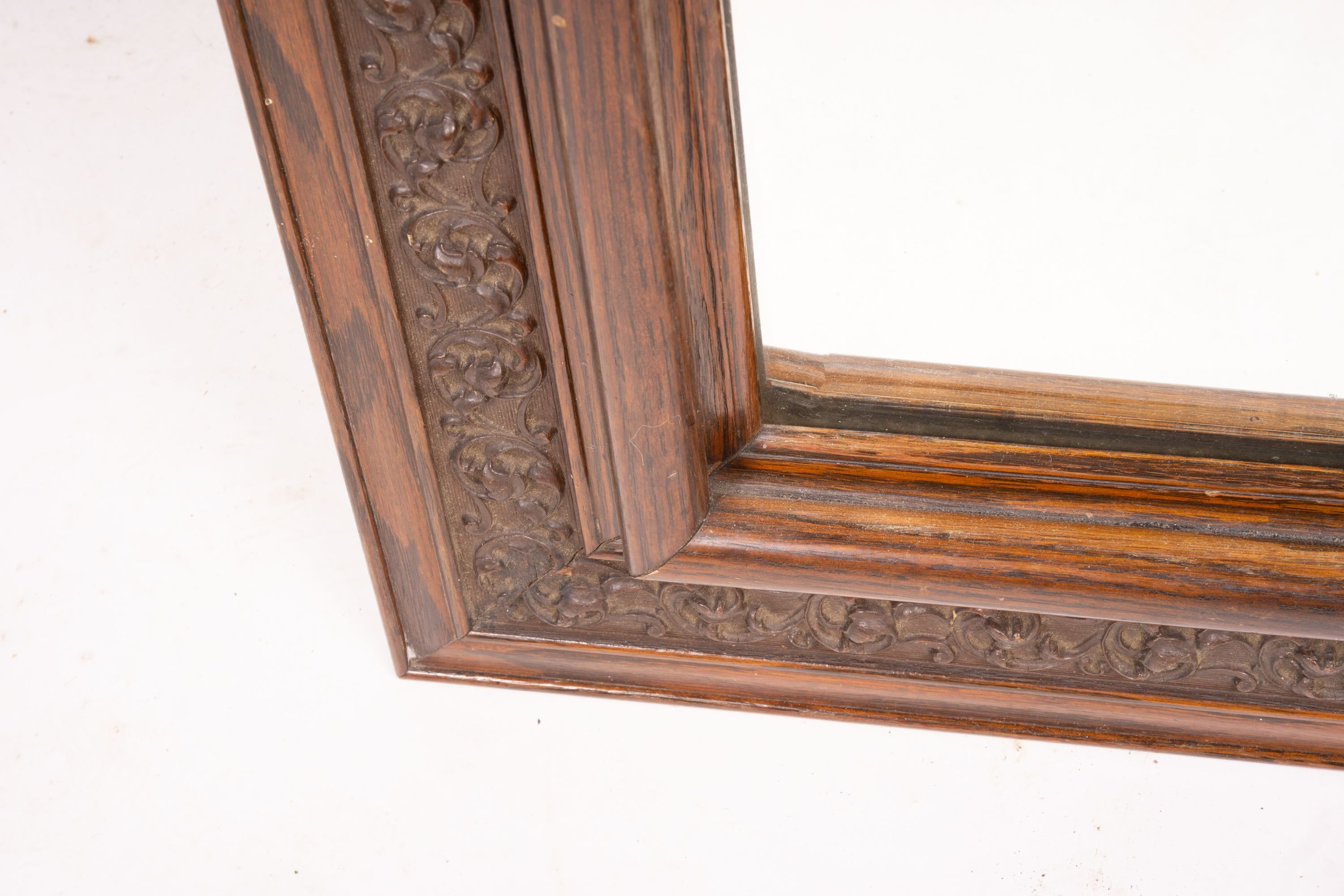 An early 20th century carved oak rectangular wall mirror, width 57cm, height 64cm